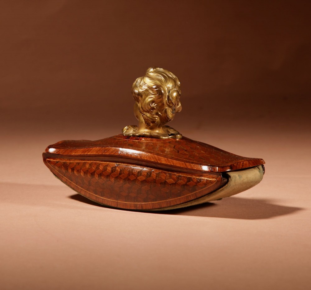 A nineteenth-century French rocker blotter featuring geometric wood parquetry inlay, a green felt underside, and a sculpted gilt bronze cherub head handle. View III