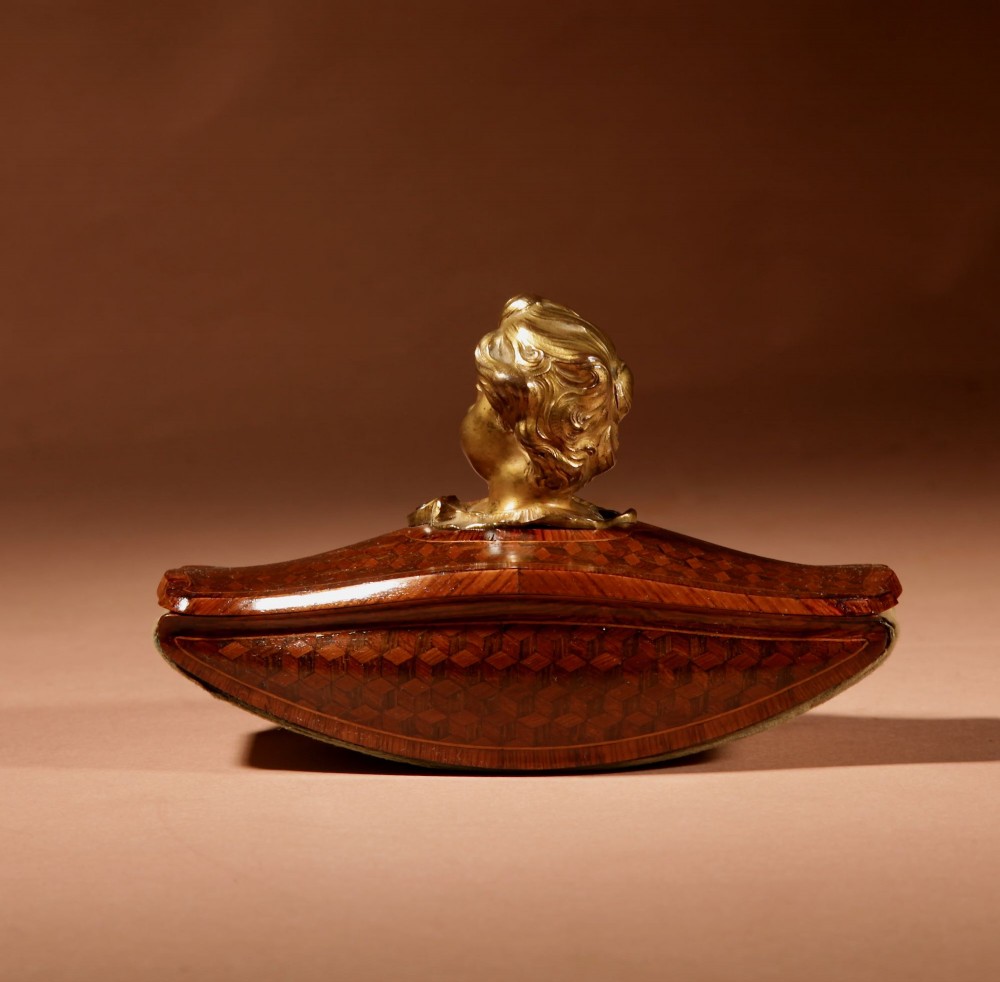 A nineteenth-century French rocker blotter featuring geometric wood parquetry inlay, a green felt underside, and a sculpted gilt bronze cherub head handle. View IV