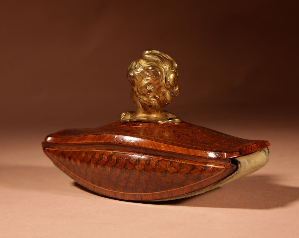 A nineteenth-century French rocker blotter featuring geometric wood parquetry inlay, a green felt underside, and a sculpted gilt bronze cherub head handle. View VIII