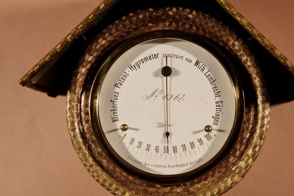 An antique late nineteenth-century brass wall-mounted Klinkerfues patent hair hygrometer weather station featuring two circular dials and a central thermometer tube. View V