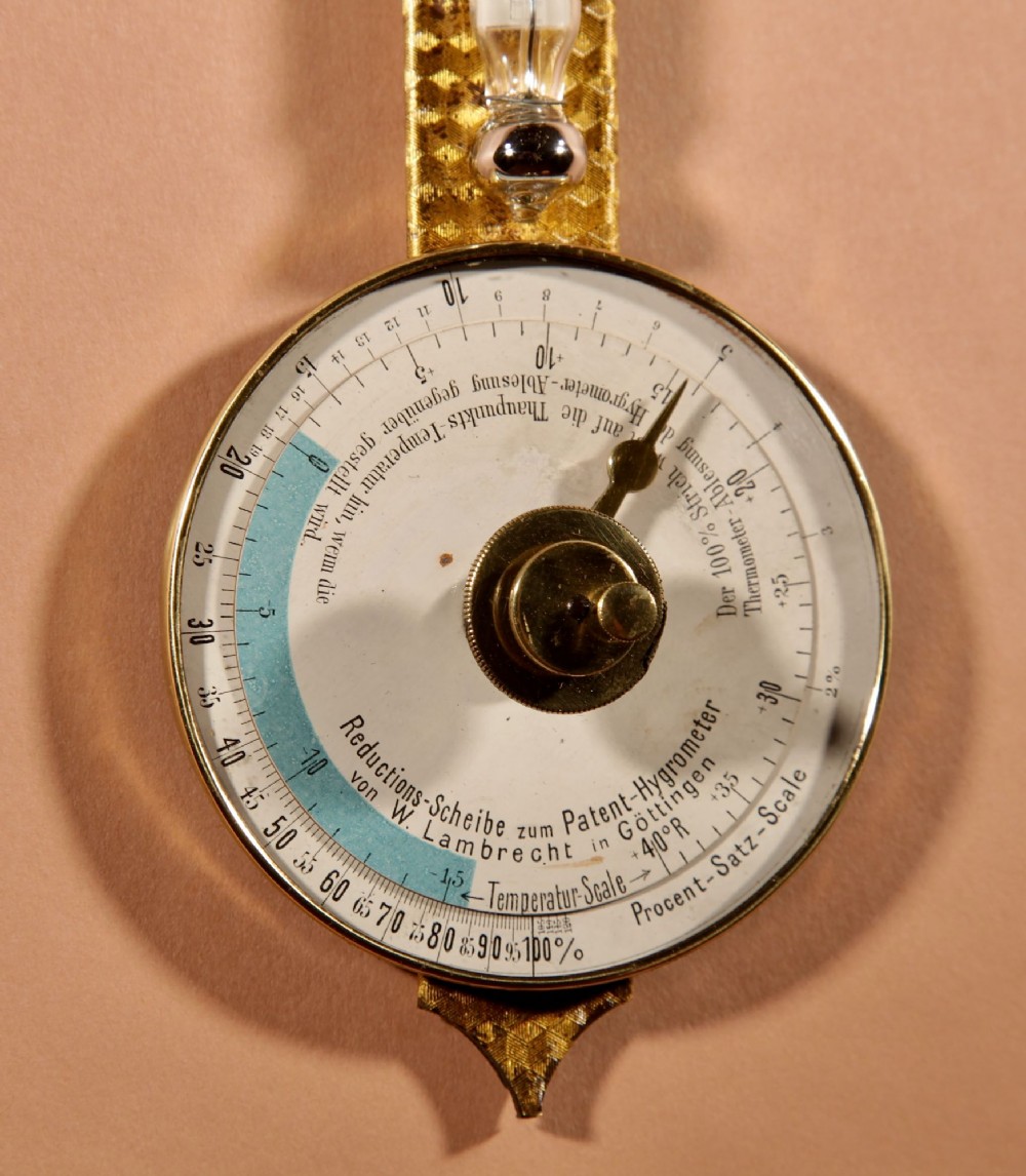 An antique late nineteenth-century brass wall-mounted Klinkerfues patent hair hygrometer weather station featuring two circular dials and a central thermometer tube. View VI