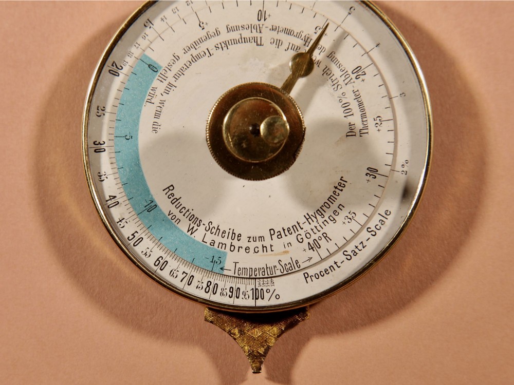 An antique late nineteenth-century brass wall-mounted Klinkerfues patent hair hygrometer weather station featuring two circular dials and a central thermometer tube. View VII