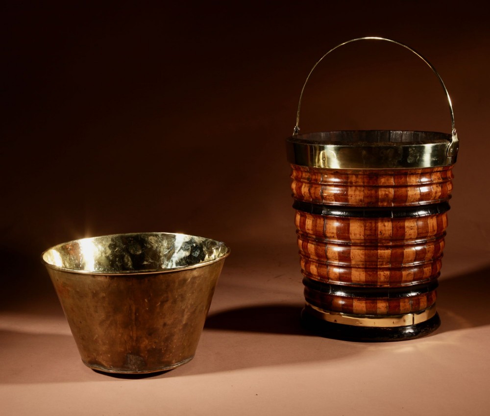 An antique coopered wooden peat bucket featuring alternating light and dark ribbed wood staves, ebonised bands, a brass rim, and a brass swing handle. View VI