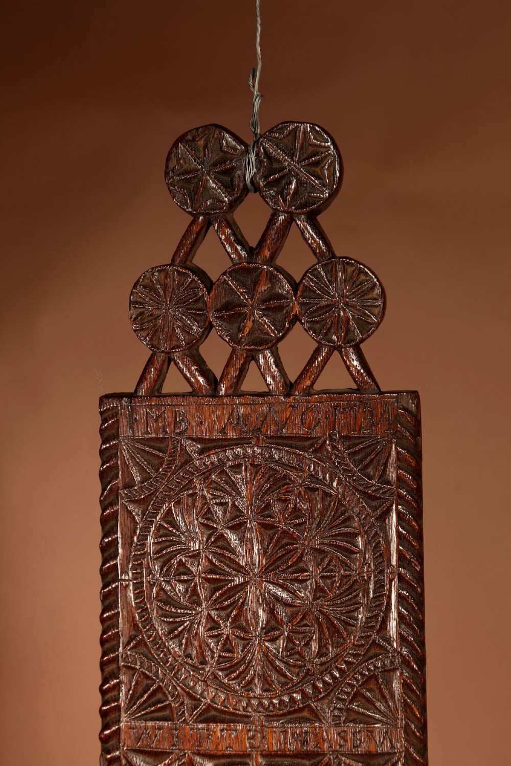 An elongated dark oak Frisian mangle board featuring intricate chip-carved geometric rosettes, carved lettering, dated 1734, and an openwork crest handle. View II