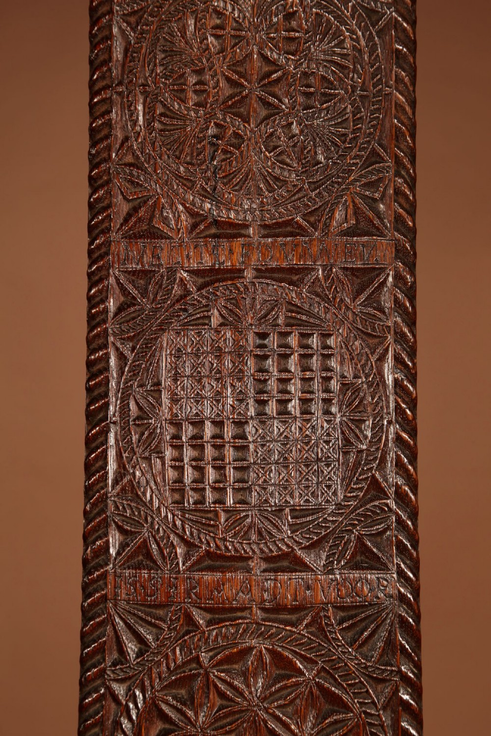 An elongated dark oak Frisian mangle board featuring intricate chip-carved geometric rosettes, carved lettering, dated 1734, and an openwork crest handle. View VI