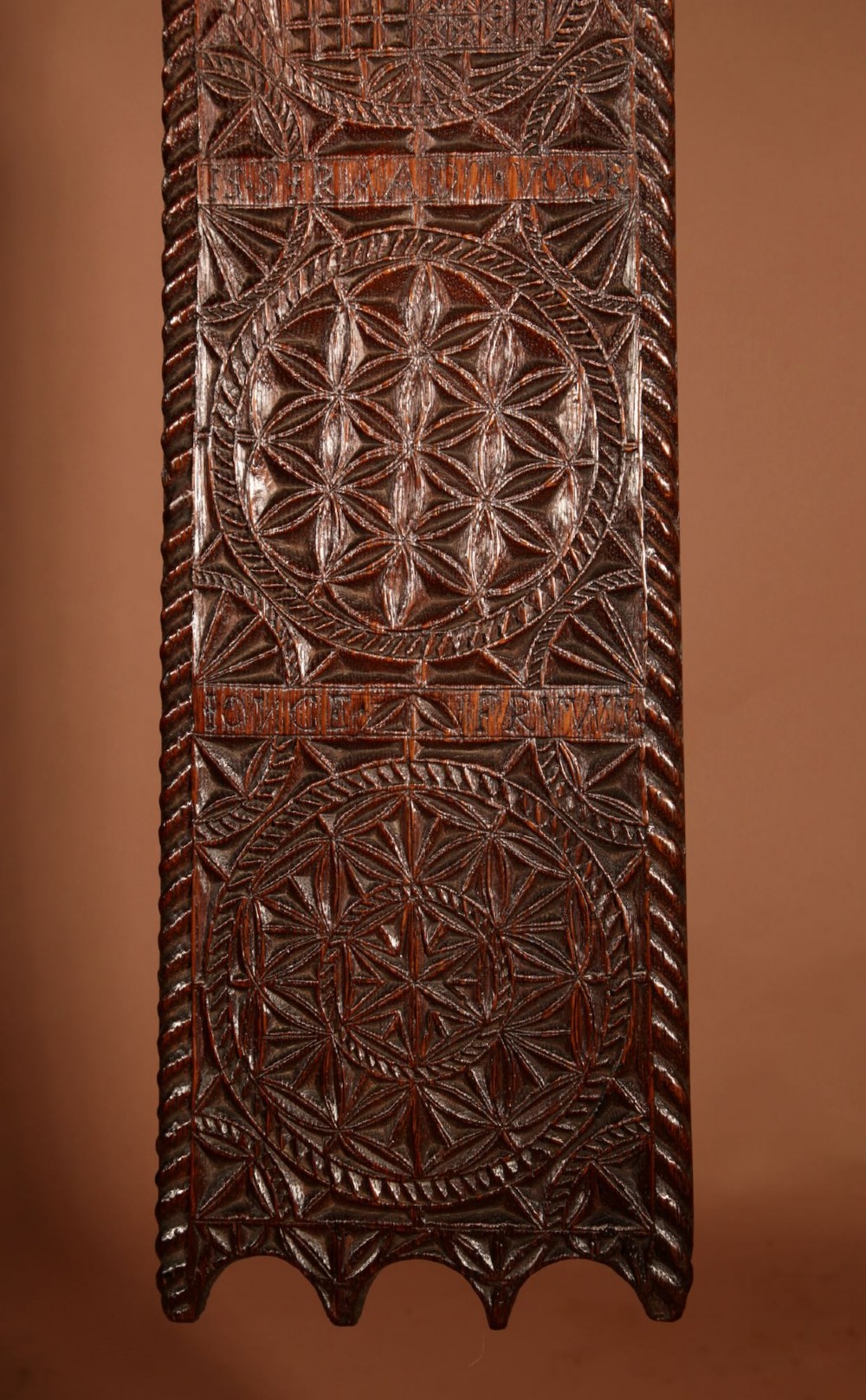 An elongated dark oak Frisian mangle board featuring intricate chip-carved geometric rosettes, carved lettering, dated 1734, and an openwork crest handle. View VII