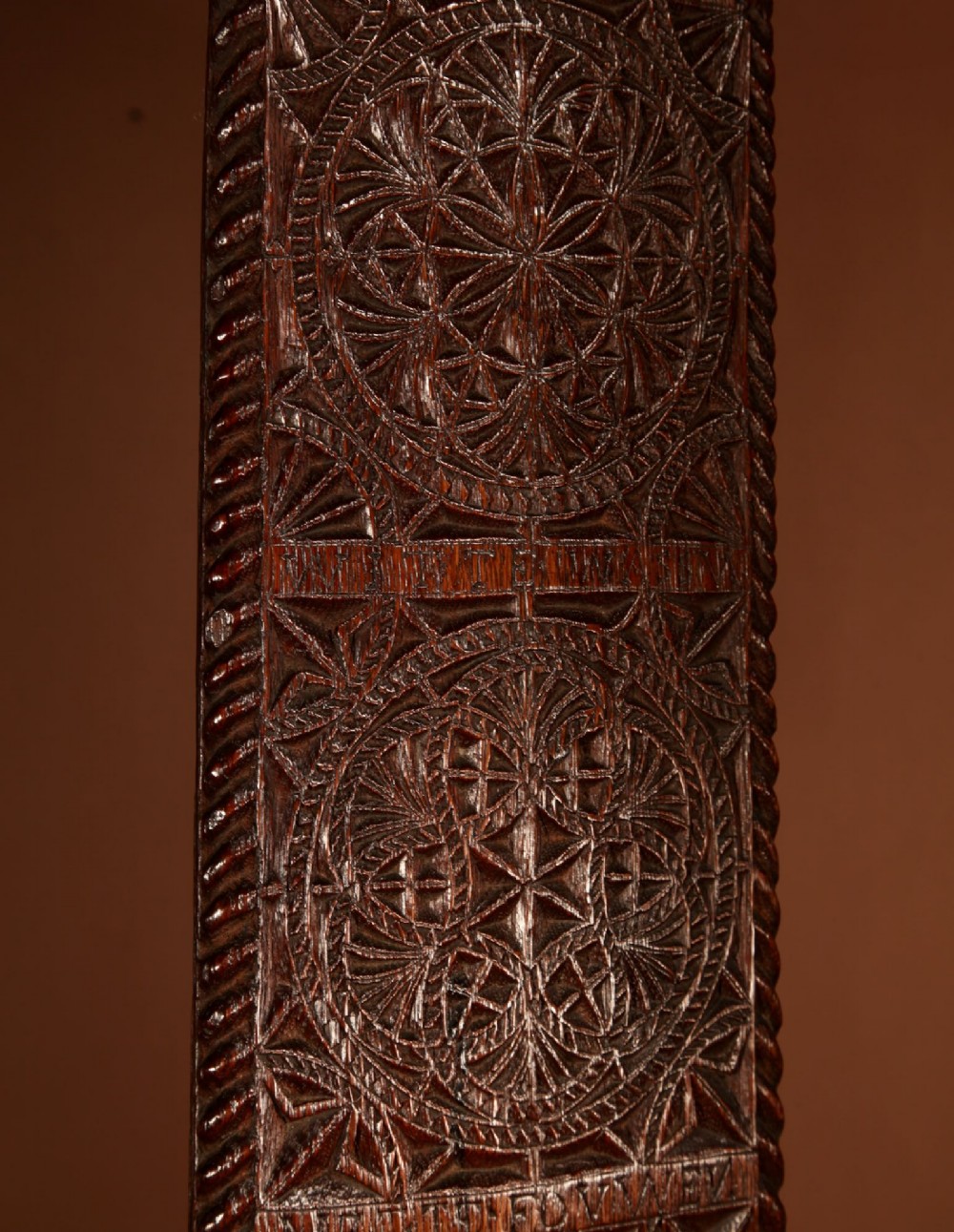 An elongated dark oak Frisian mangle board featuring intricate chip-carved geometric rosettes, carved lettering, dated 1734, and an openwork crest handle. View IX
