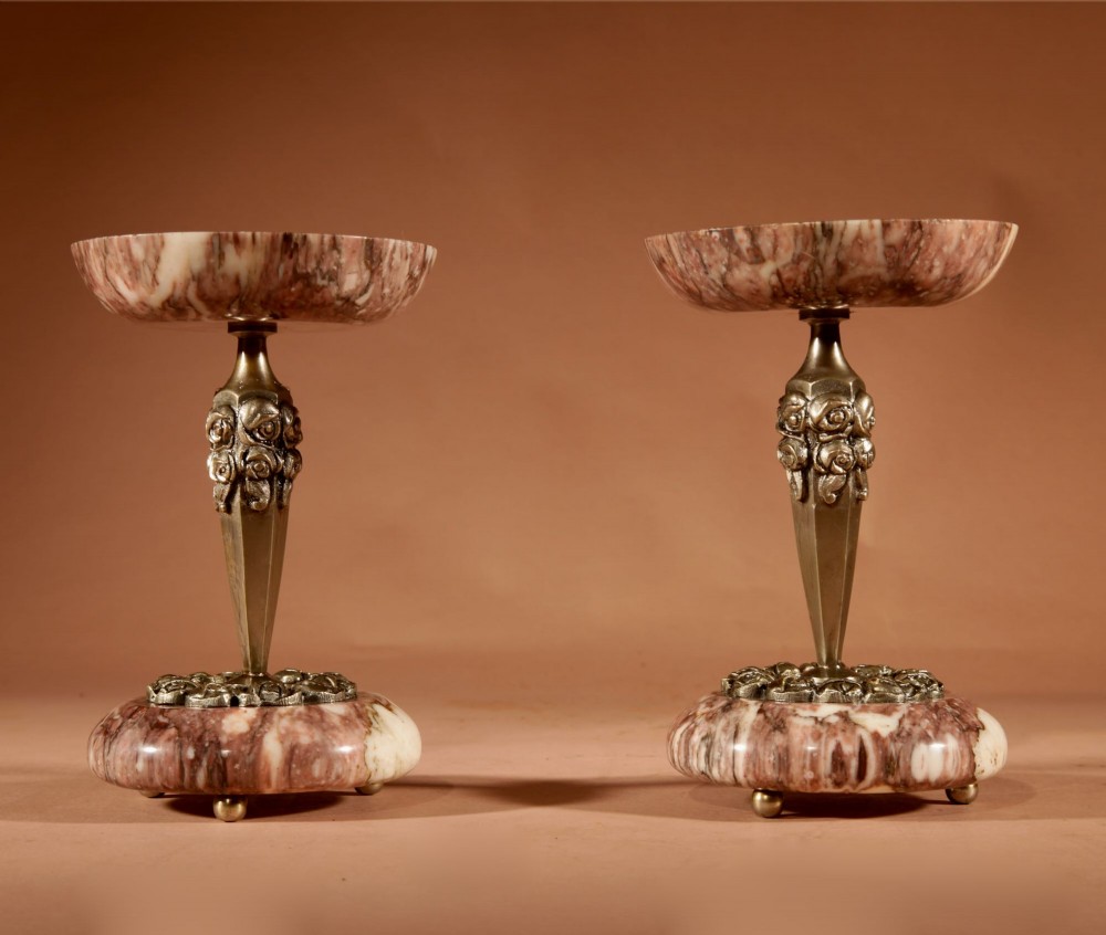 A three-piece French Art Deco clock garniture crafted from veined rose marble with brass floral embellishments and matching side tazzas. View IX