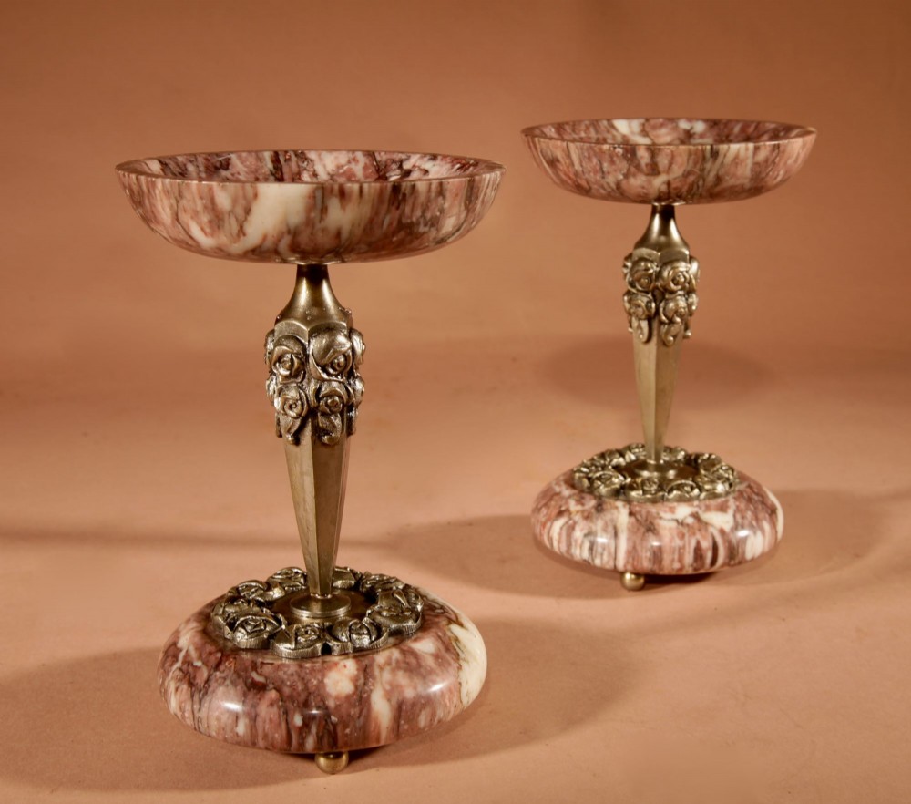 A three-piece French Art Deco clock garniture crafted from veined rose marble with brass floral embellishments and matching side tazzas. View XI