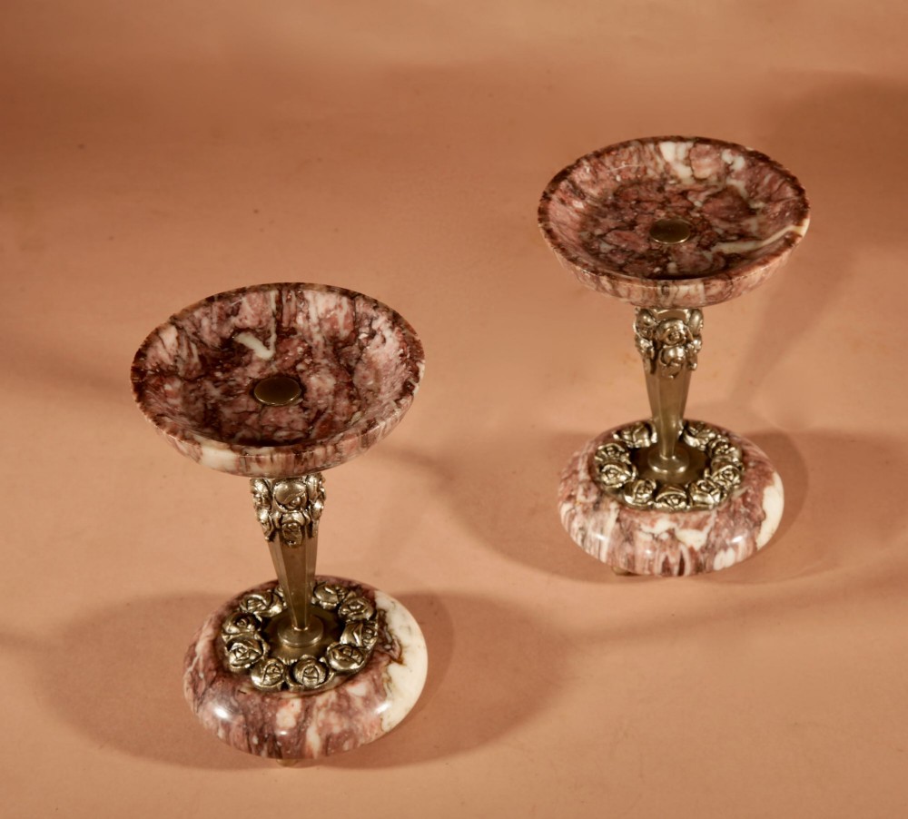 A three-piece French Art Deco clock garniture crafted from veined rose marble with brass floral embellishments and matching side tazzas. View XII