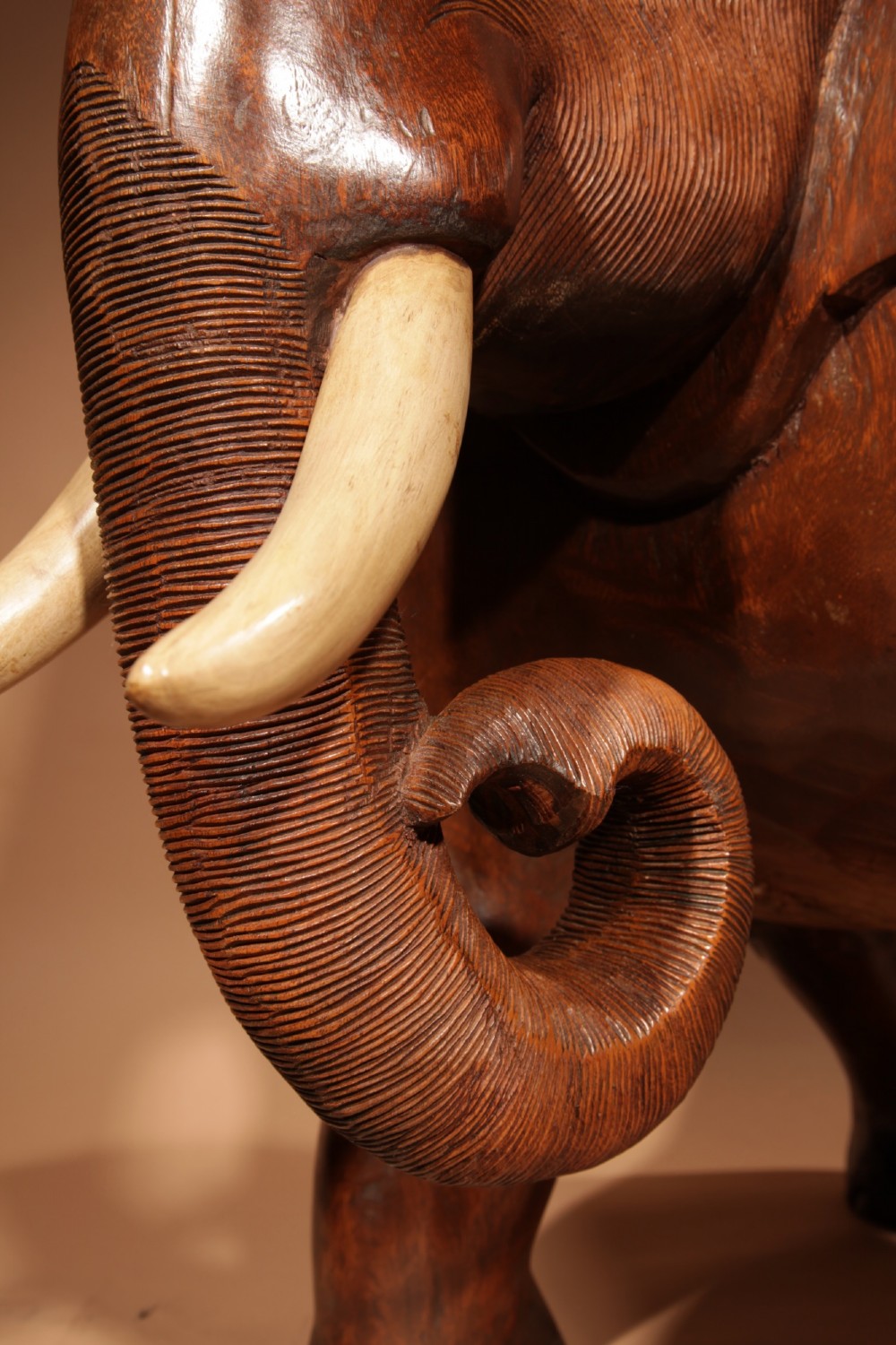 A pair of heavy hand-carved wooden armchairs sculpted in the form of standing elephants with textured hides and light-coloured tusks. View XI