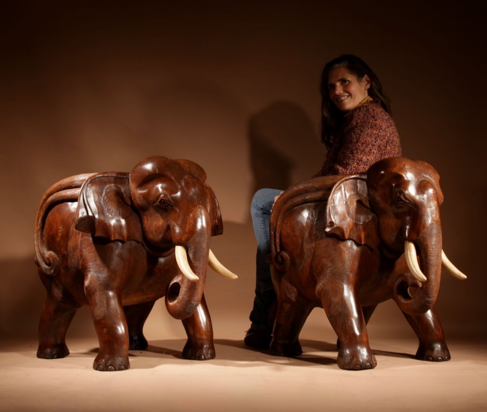 A pair of heavy hand-carved wooden armchairs sculpted in the form of standing elephants with textured hides and light-coloured tusks. View XV