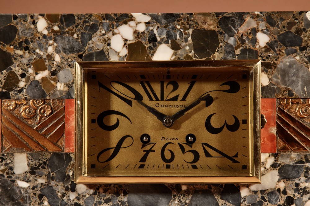 An Art Deco clock garniture set constructed from dark speckled stone and coral marble featuring a central rectangular clock with gilt numerals and two matching side pieces. View III