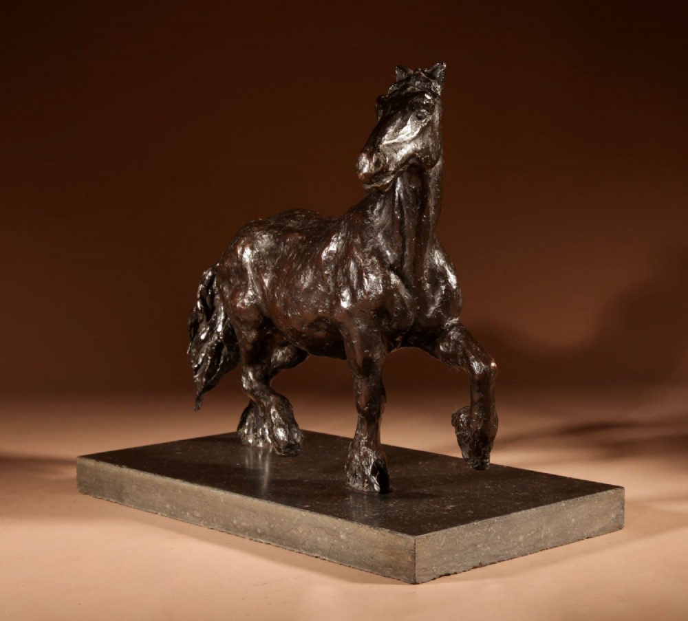 A dark patinated bronze sculpture of a muscular draft horse with one raised foreleg mounted on a rectangular stone base. View V