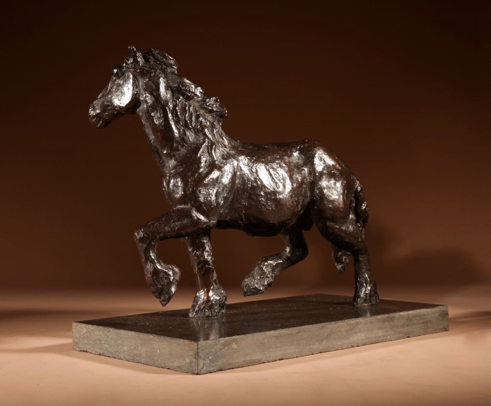 A dark patinated bronze sculpture of a muscular draft horse with one raised foreleg mounted on a rectangular stone base. View VI