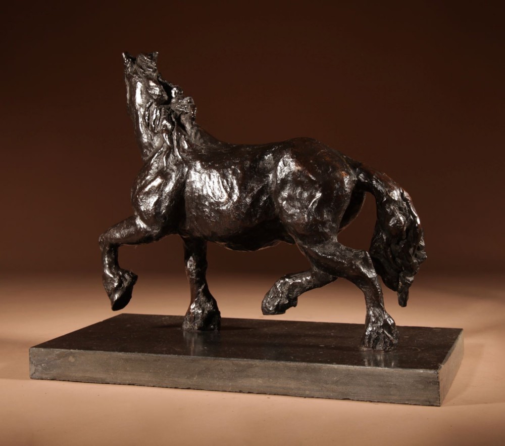 A dark patinated bronze sculpture of a muscular draft horse with one raised foreleg mounted on a rectangular stone base. View VII