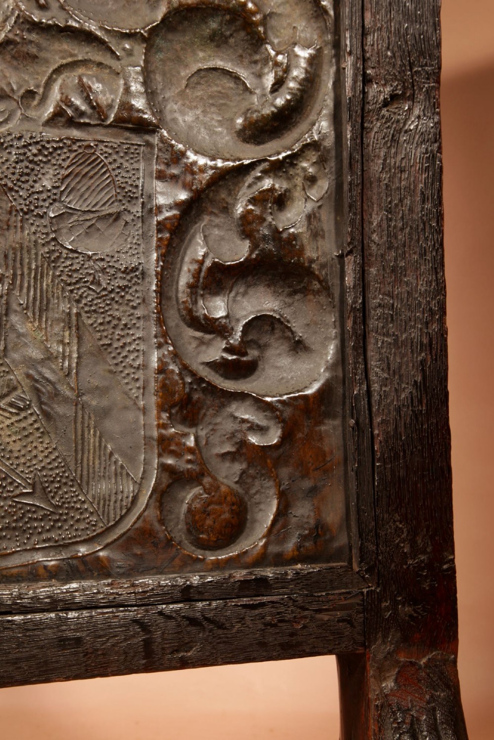 An antique dark oak fire screen featuring a central chased brass panel depicting a coat of arms with an eagle and acorns. View XI