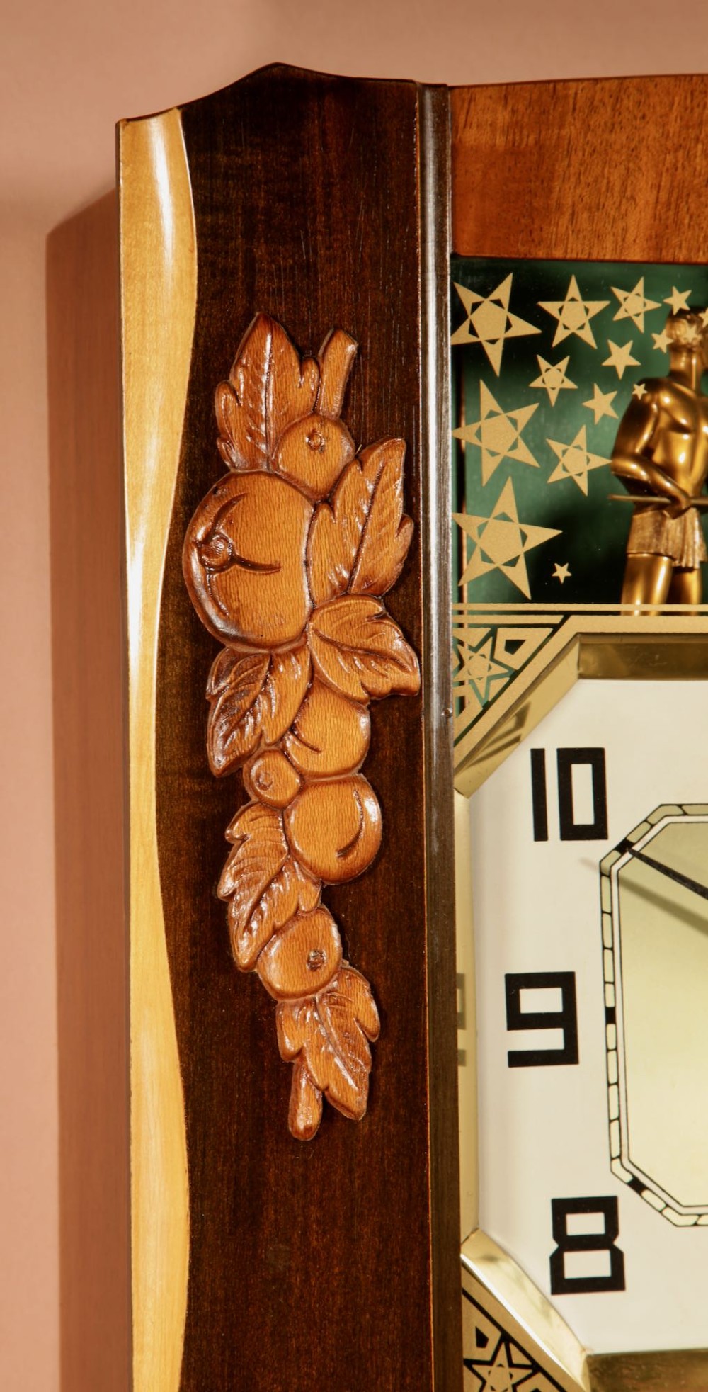 An Art Deco carved walnut wall clock by Odo featuring a brass automaton bell striker and a Venetian glass lower window. View VII