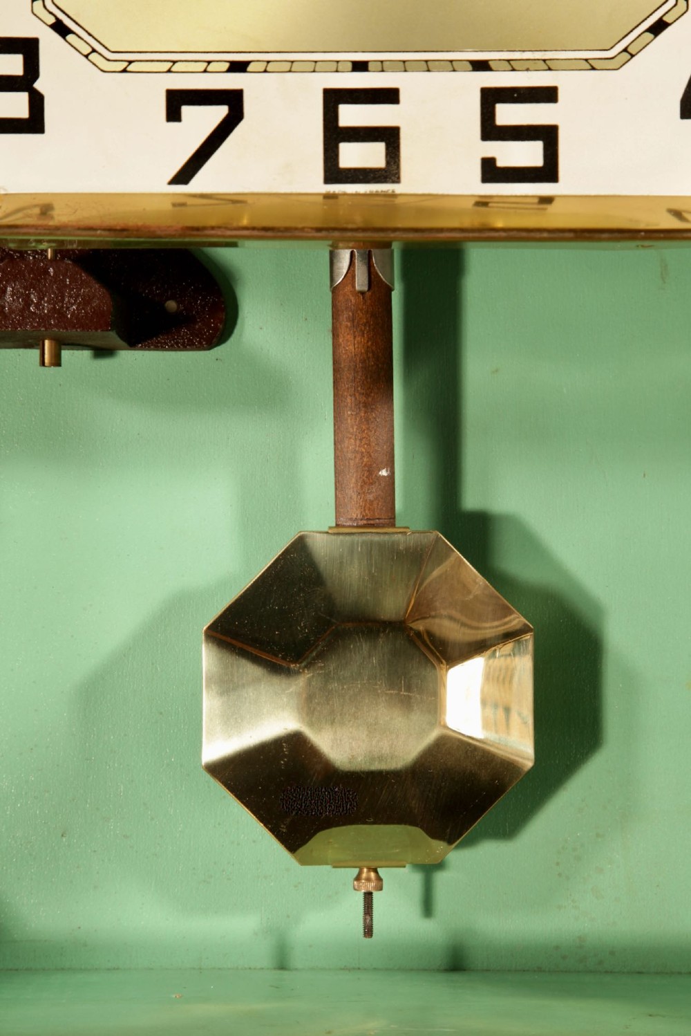 An Art Deco carved walnut wall clock by Odo featuring a brass automaton bell striker and a Venetian glass lower window. View IX