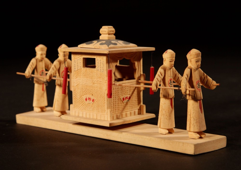 A collection of nine hand-carved light wood miniatures depicting various traditional Chinese daily life trades, vehicles, and activities. View IV