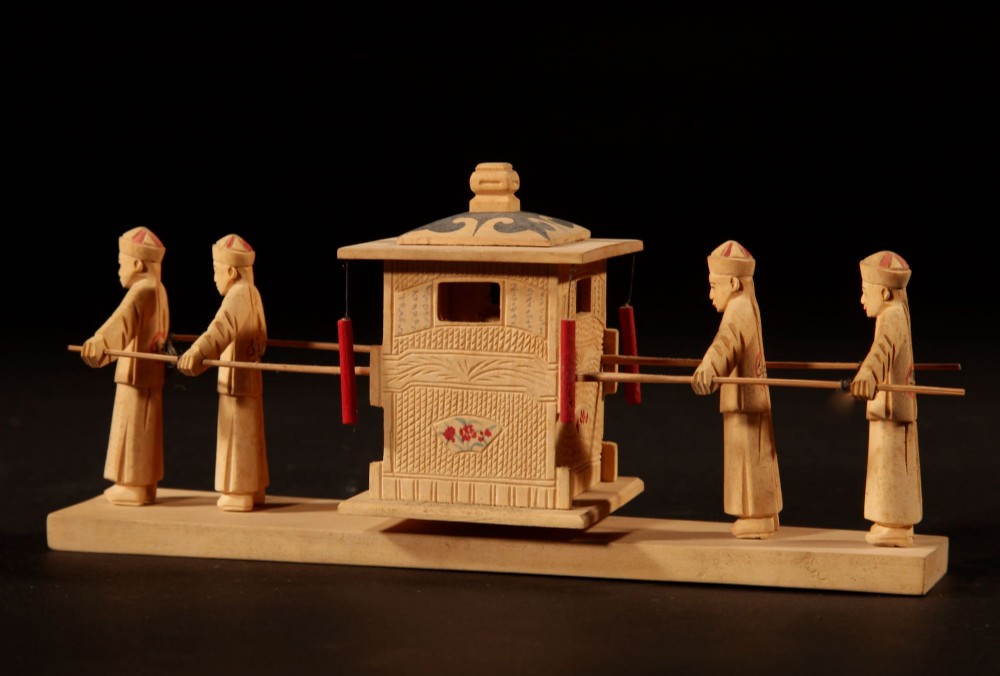 A collection of nine hand-carved light wood miniatures depicting various traditional Chinese daily life trades, vehicles, and activities. View VI