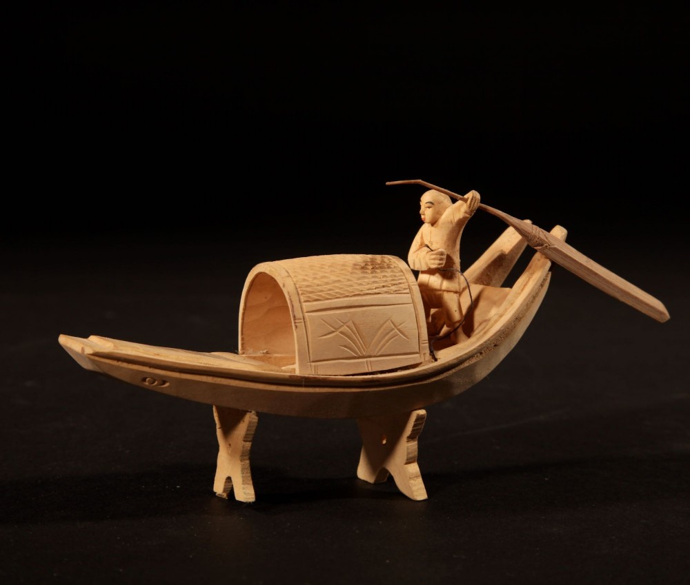 A collection of nine hand-carved light wood miniatures depicting various traditional Chinese daily life trades, vehicles, and activities. View VII