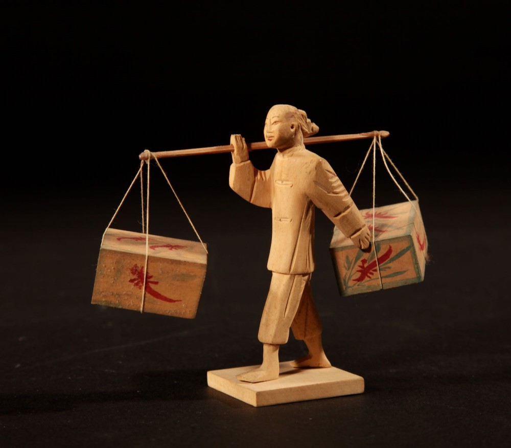 A collection of nine hand-carved light wood miniatures depicting various traditional Chinese daily life trades, vehicles, and activities. View VIII