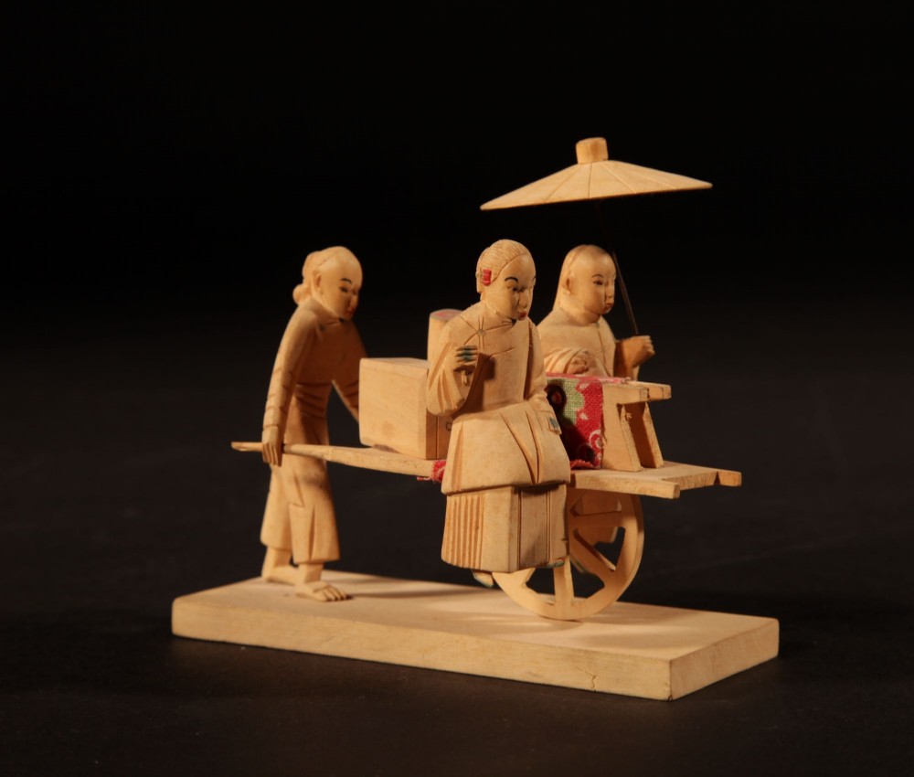 A collection of nine hand-carved light wood miniatures depicting various traditional Chinese daily life trades, vehicles, and activities. View XII