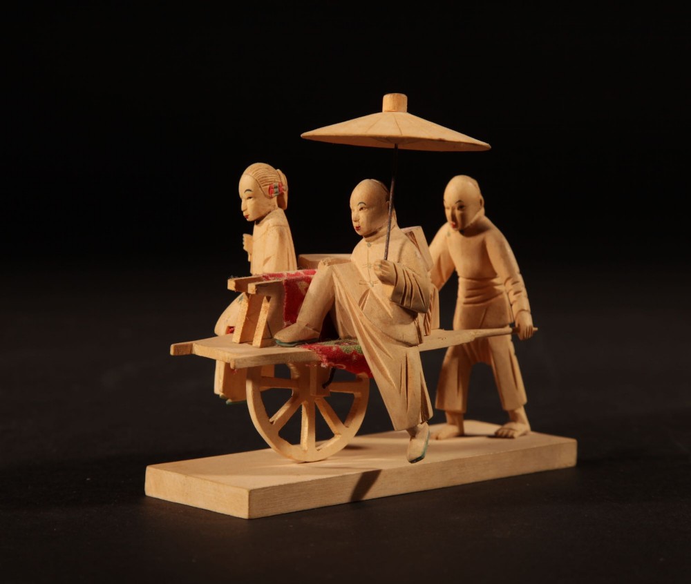 A collection of nine hand-carved light wood miniatures depicting various traditional Chinese daily life trades, vehicles, and activities. View XIII