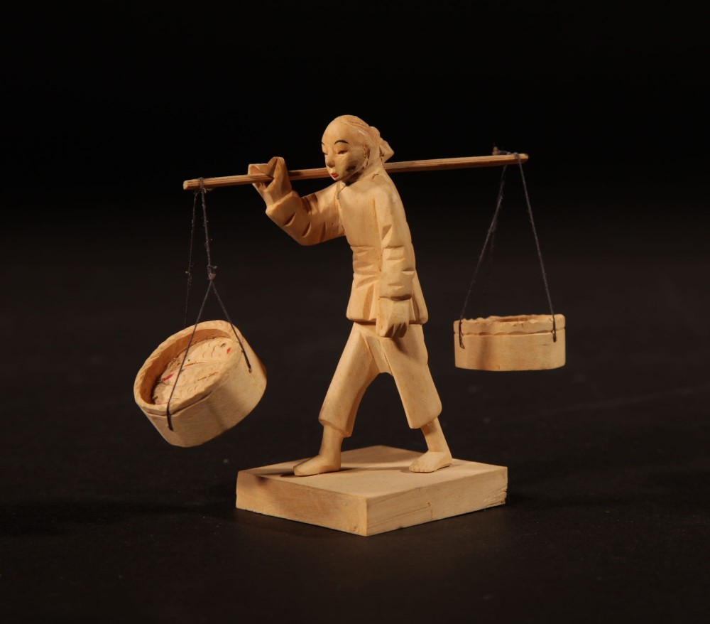 A collection of nine hand-carved light wood miniatures depicting various traditional Chinese daily life trades, vehicles, and activities. View XIV