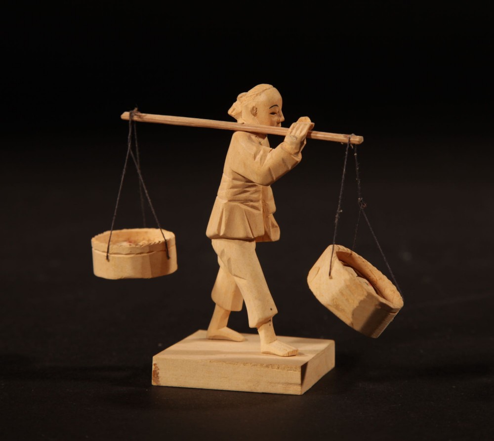 A collection of nine hand-carved light wood miniatures depicting various traditional Chinese daily life trades, vehicles, and activities. View XV