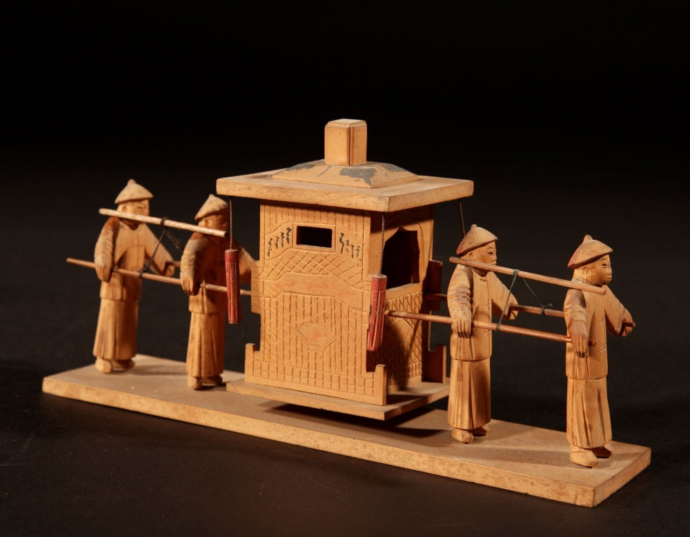 A collection of seven light-coloured Chinese wood carvings depicting figures engaged in traditional daily activities including weaving, fishing, and carrying a sedan chair. View III