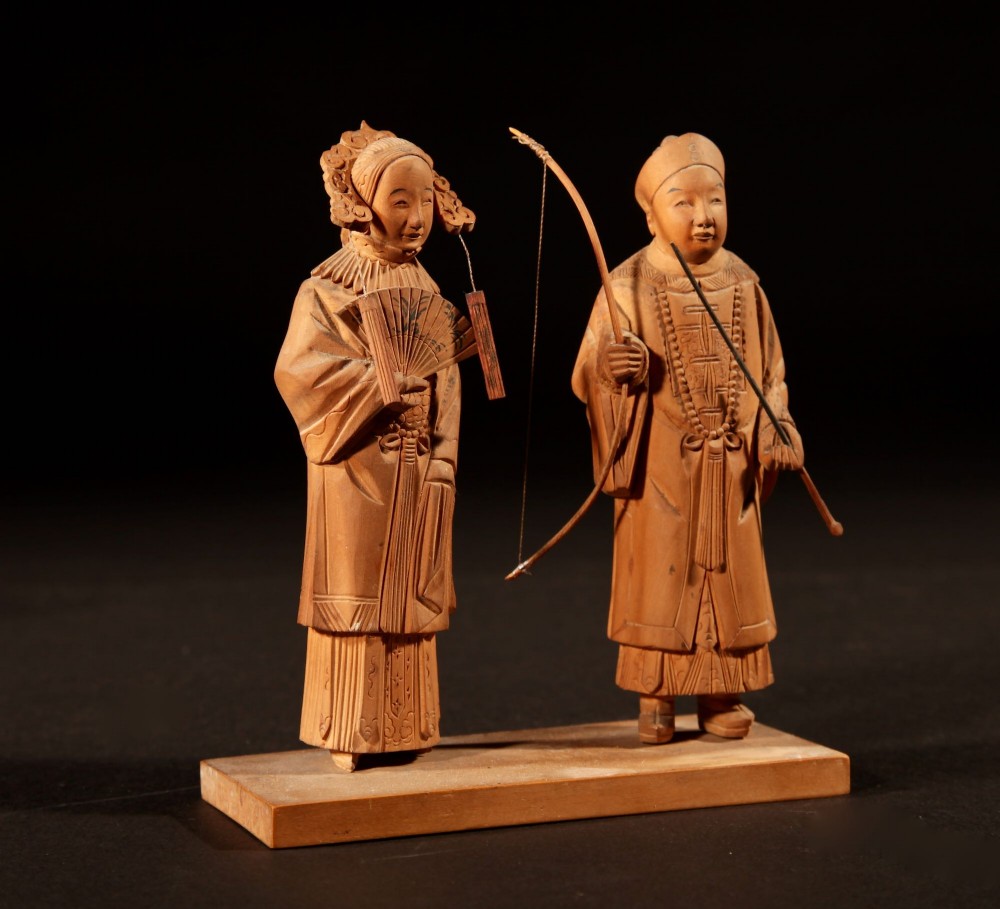 A collection of seven light-coloured Chinese wood carvings depicting figures engaged in traditional daily activities including weaving, fishing, and carrying a sedan chair. View VI