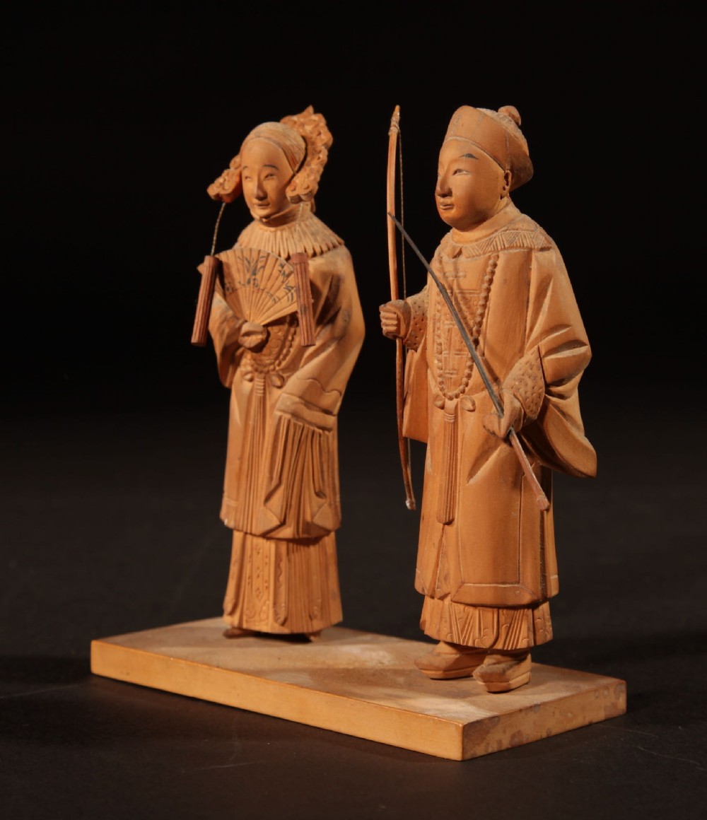 A collection of seven light-coloured Chinese wood carvings depicting figures engaged in traditional daily activities including weaving, fishing, and carrying a sedan chair. View VII