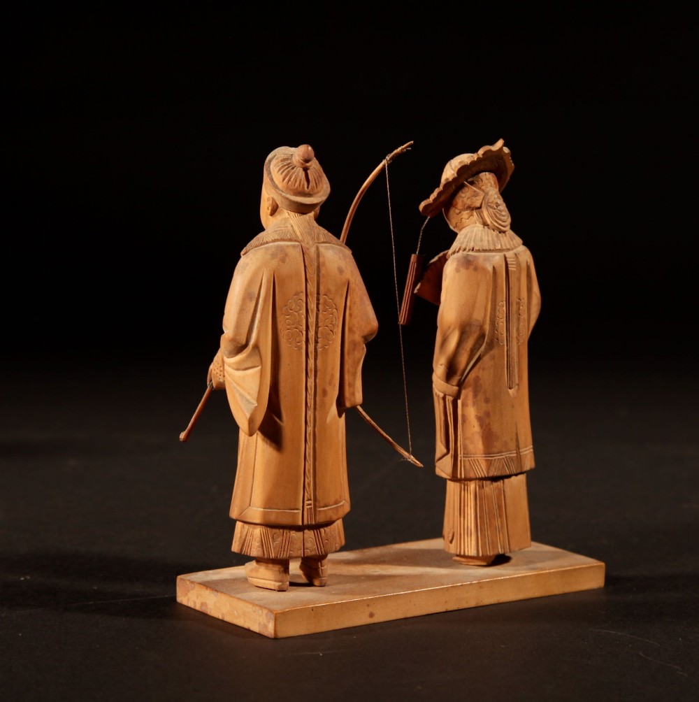 A collection of seven light-coloured Chinese wood carvings depicting figures engaged in traditional daily activities including weaving, fishing, and carrying a sedan chair. View VIII