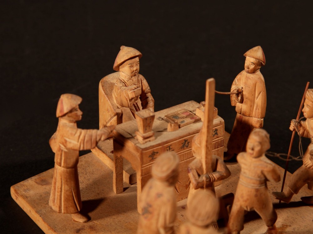 A collection of seven light-coloured Chinese wood carvings depicting figures engaged in traditional daily activities including weaving, fishing, and carrying a sedan chair. View XIV