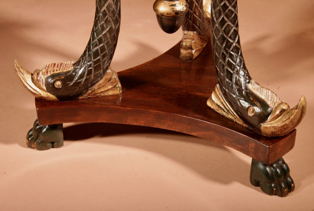 A French Empire mahogany slatted wine cooler featuring a brass liner and supported by three carved ebonised dolphin legs on a triform base with paw feet. View VIII
