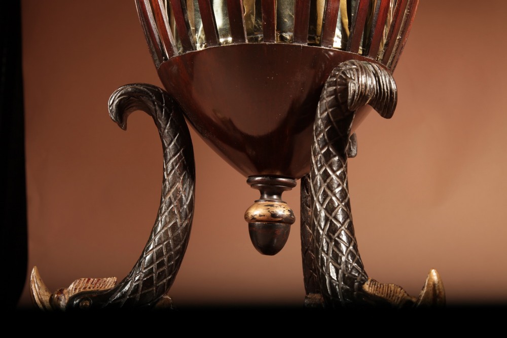A French Empire mahogany slatted wine cooler featuring a brass liner and supported by three carved ebonised dolphin legs on a triform base with paw feet. View XII