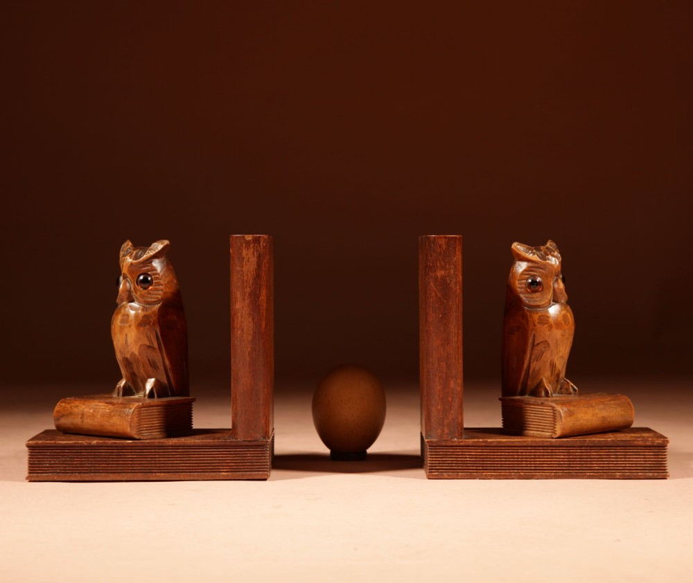 A pair of hand-carved wooden bookends featuring owls with glass eyes perched on carved book bases. View II