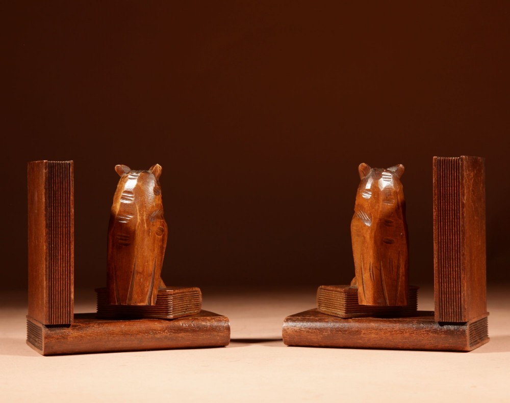 A pair of hand-carved wooden bookends featuring owls with glass eyes perched on carved book bases. View V