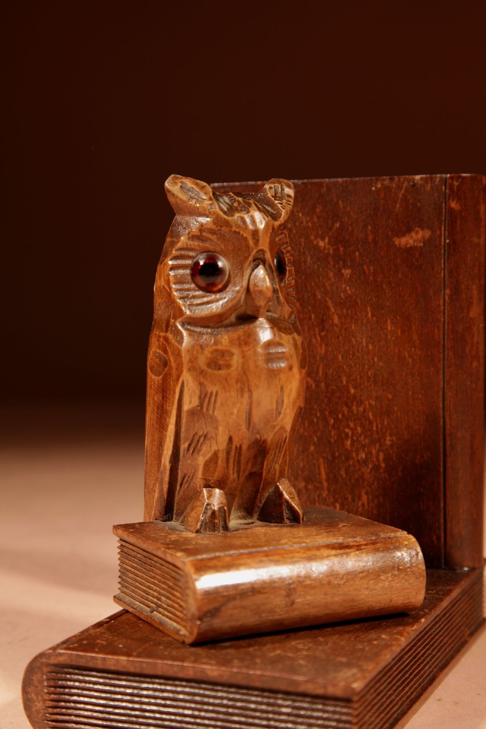 A pair of hand-carved wooden bookends featuring owls with glass eyes perched on carved book bases. View VIII