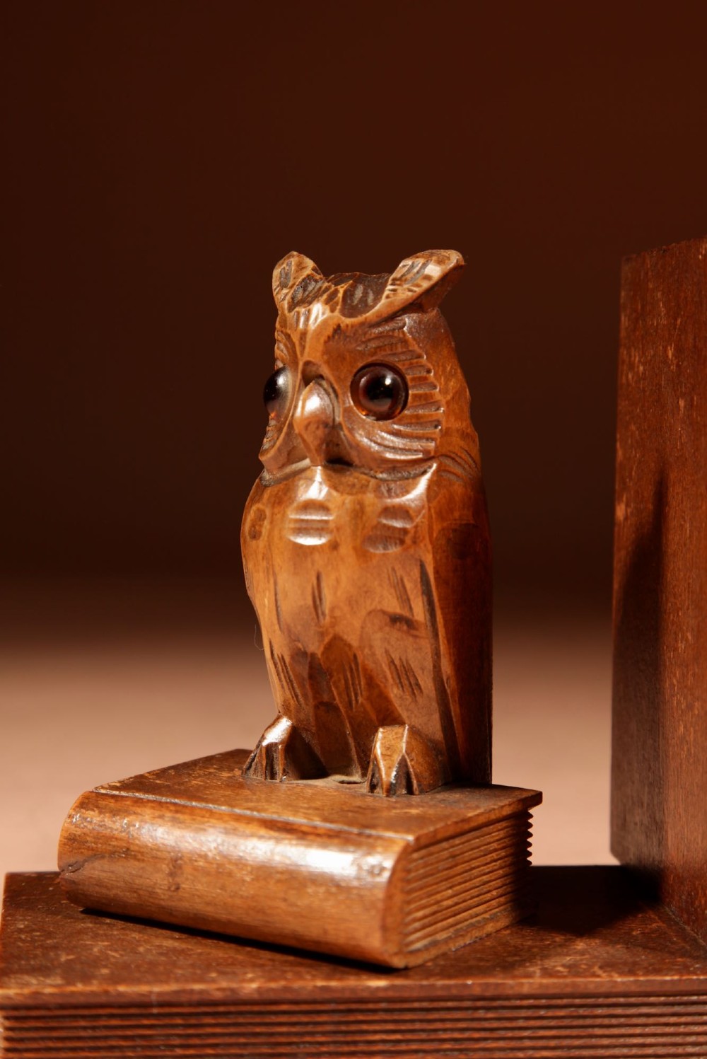 A pair of hand-carved wooden bookends featuring owls with glass eyes perched on carved book bases. View IX