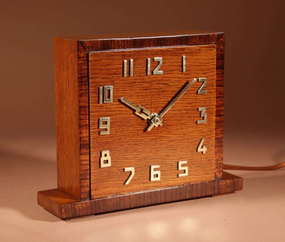 A square Art Deco wooden mantel clock crafted from oak and rosewood with applied brass numerals and hands. View III