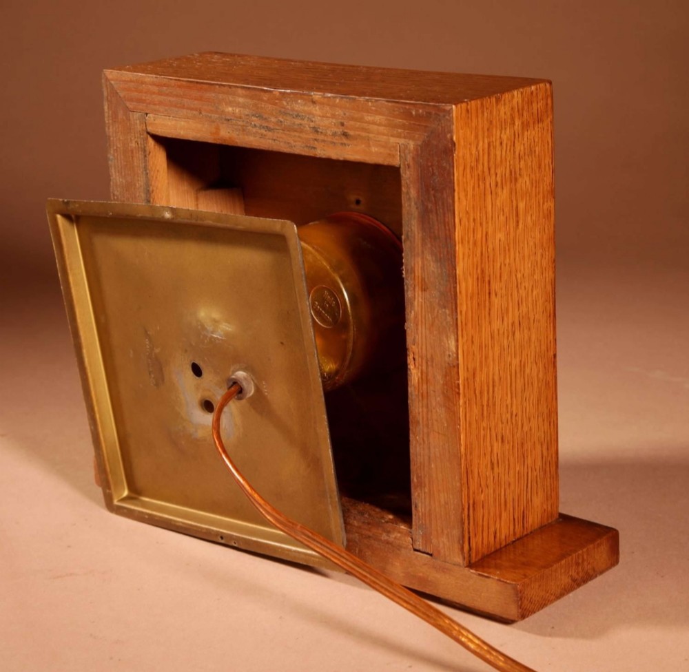 A square Art Deco wooden mantel clock crafted from oak and rosewood with applied brass numerals and hands. View IV