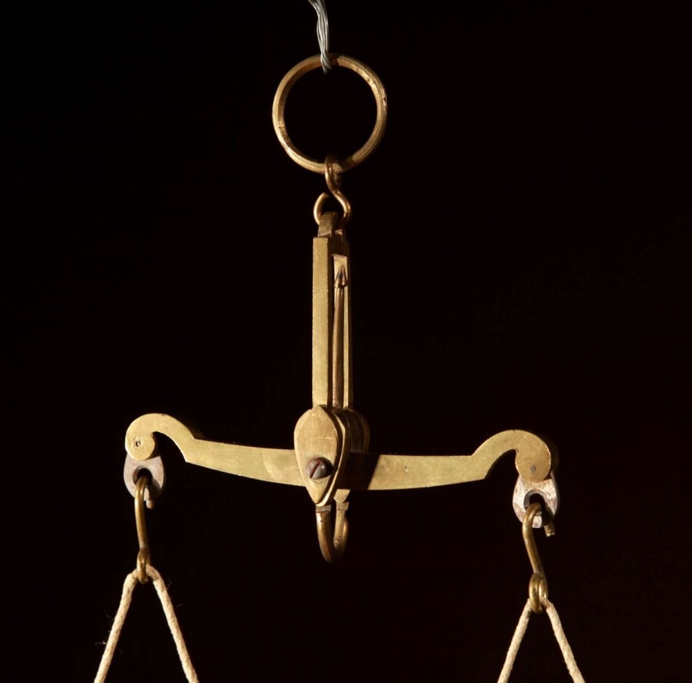 An 1846 Dutch brass bushel balance set featuring a balance beam, two cylindrical brass measuring buckets, calibrated brass weights, a wooden striker, and a striped fabric pouch. View VII