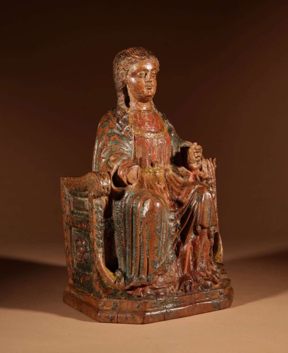 A 16th-century carved walnut statue depicting the Madonna seated on a throne with visible remnants of red and green polychrome paint. View II
