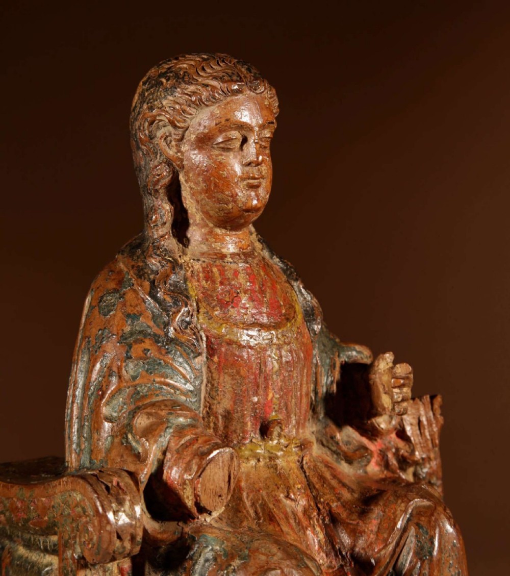 A 16th-century carved walnut statue depicting the Madonna seated on a throne with visible remnants of red and green polychrome paint. View III