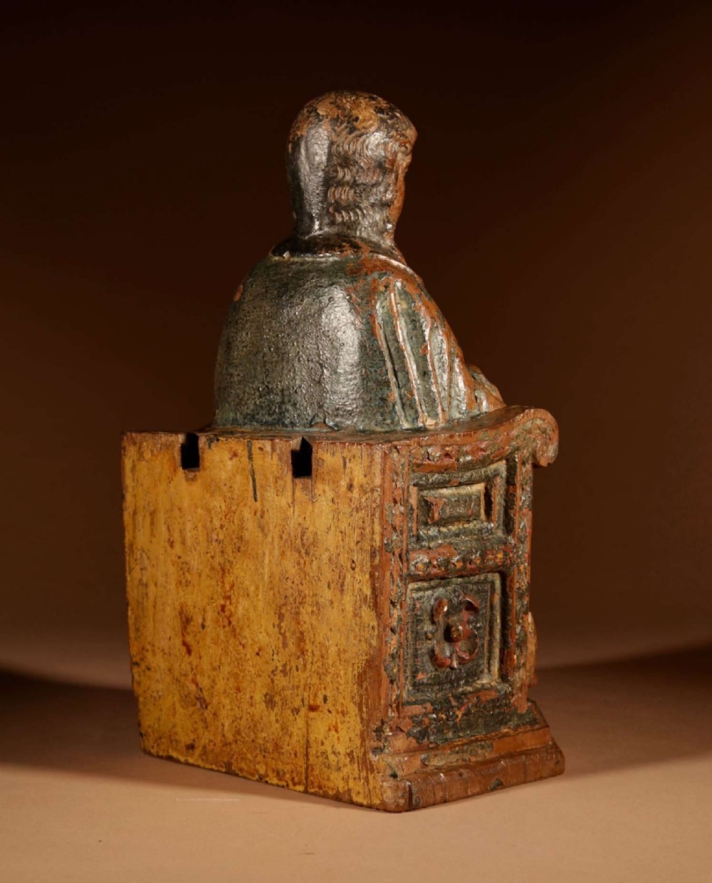 A 16th-century carved walnut statue depicting the Madonna seated on a throne with visible remnants of red and green polychrome paint. View V