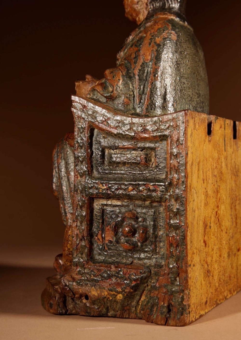 A 16th-century carved walnut statue depicting the Madonna seated on a throne with visible remnants of red and green polychrome paint. View VII