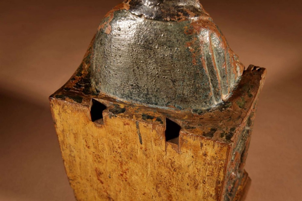 A 16th-century carved walnut statue depicting the Madonna seated on a throne with visible remnants of red and green polychrome paint. View XII